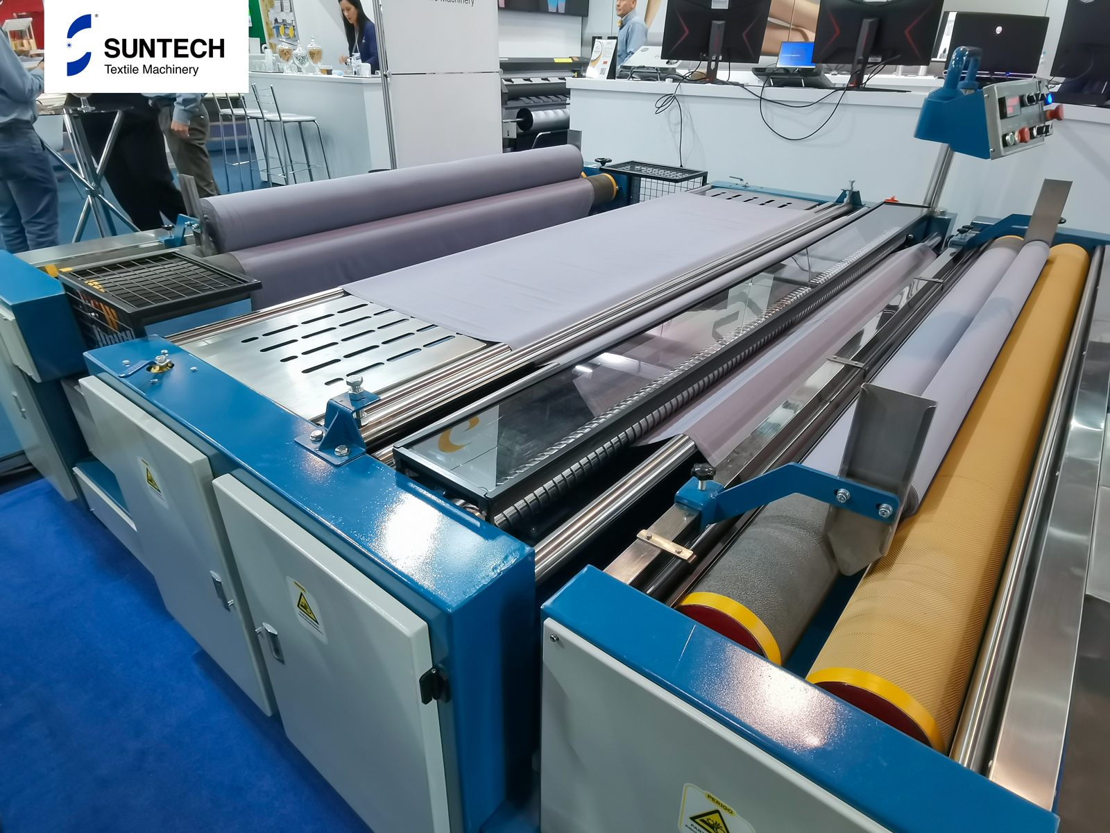 Fabric Relaxing Machine in Operation at a Textile Machinery Exhibition